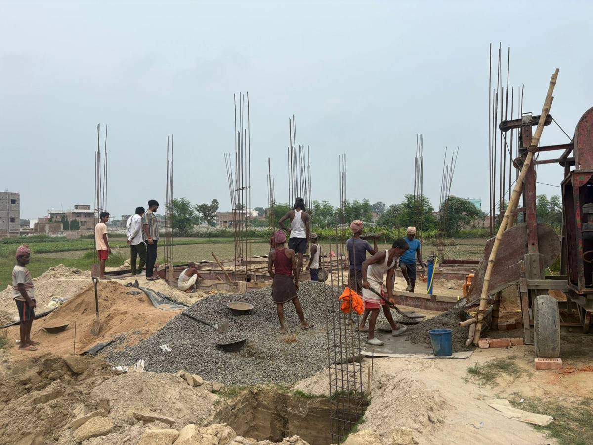 Concrete mixing beside foundation beams