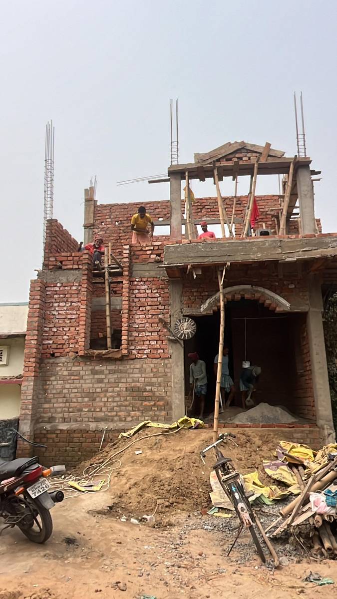 Brick house with arched entrance, upper floor in progress